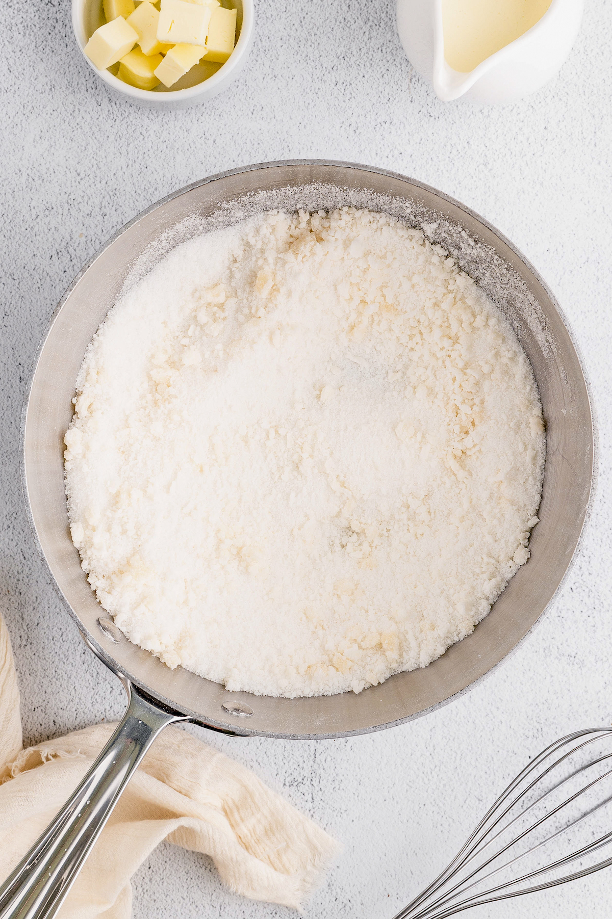 Adding the sugar to the pan.