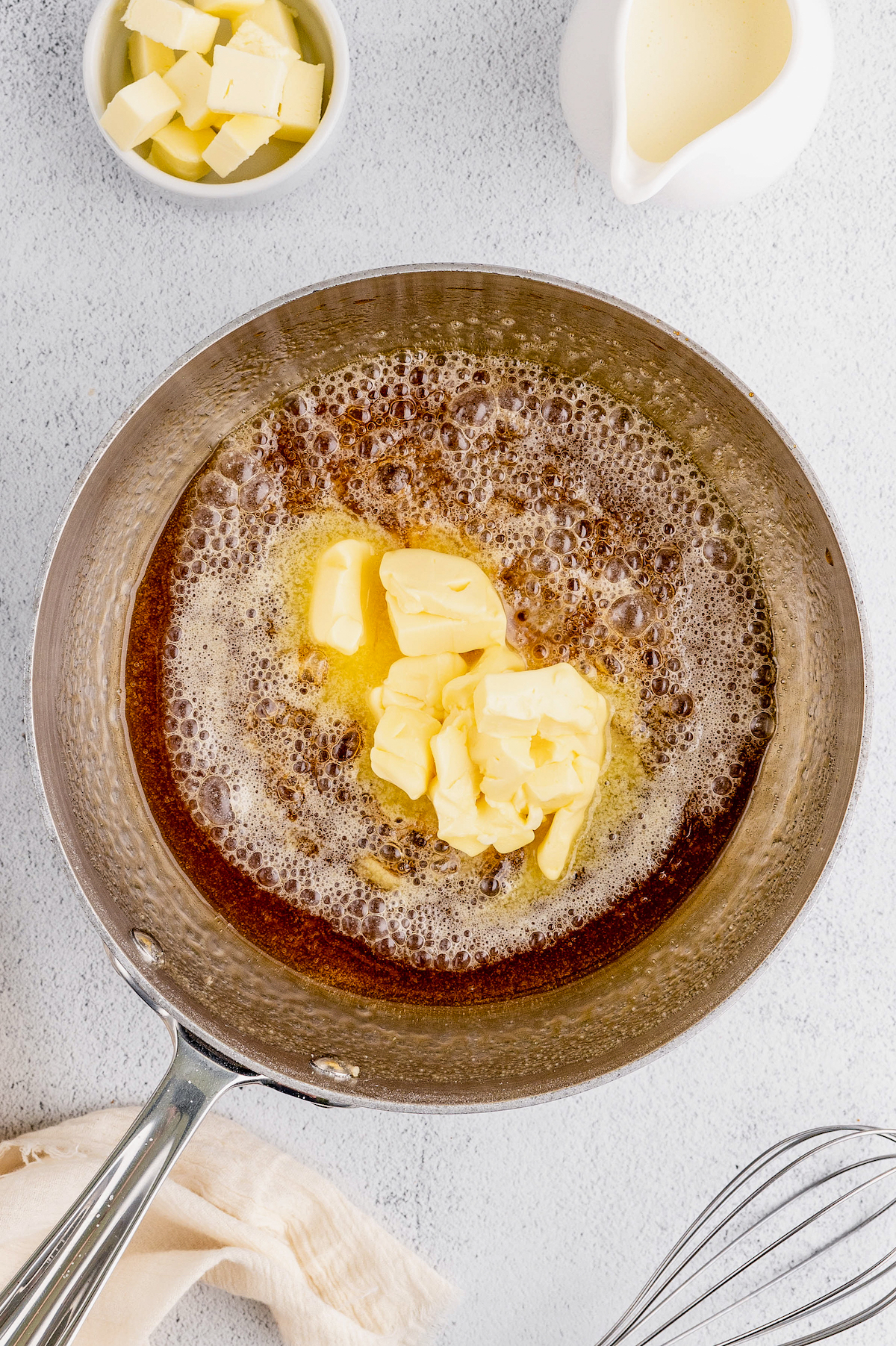 Melting the butter in the pan.