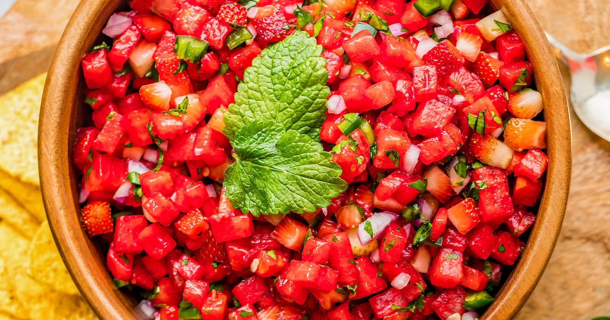 A bowl of strawberry watermelon salsa with jalapeños and fresh mint on top.