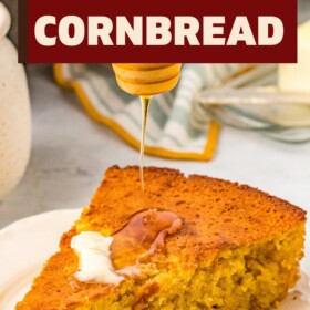 Honey being drizzled on a slice of cornbread with butter melted on top.