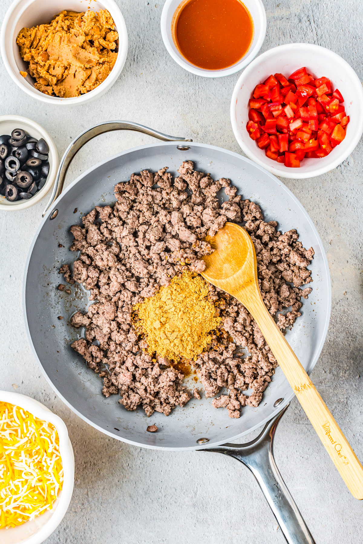 Ground beef and taco seasoning in a skillet.