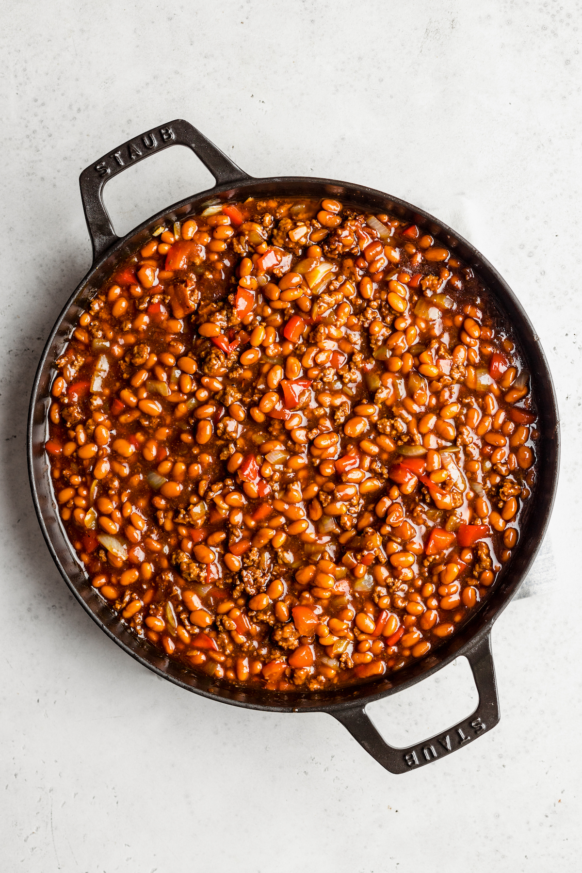 A skillet full of beans and ground beef.