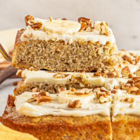 Lifting a slice of banana bread cake with a cake server.