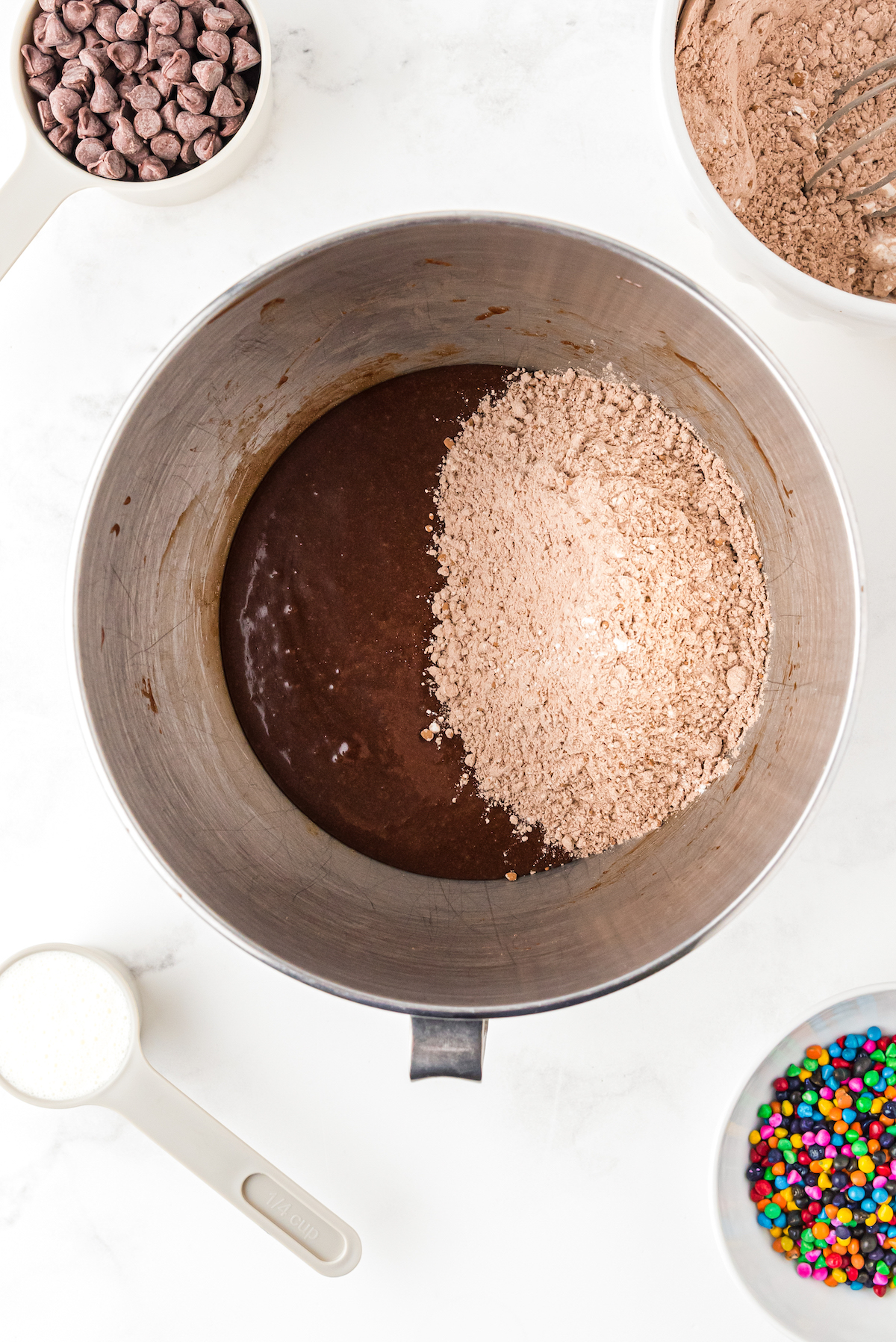 Chocolate batter with dry ingredients being mixed in.