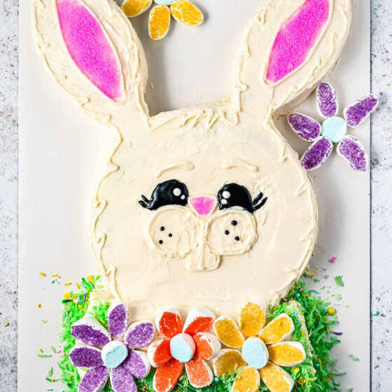 A decorated Easter bunny cake on a cake board.