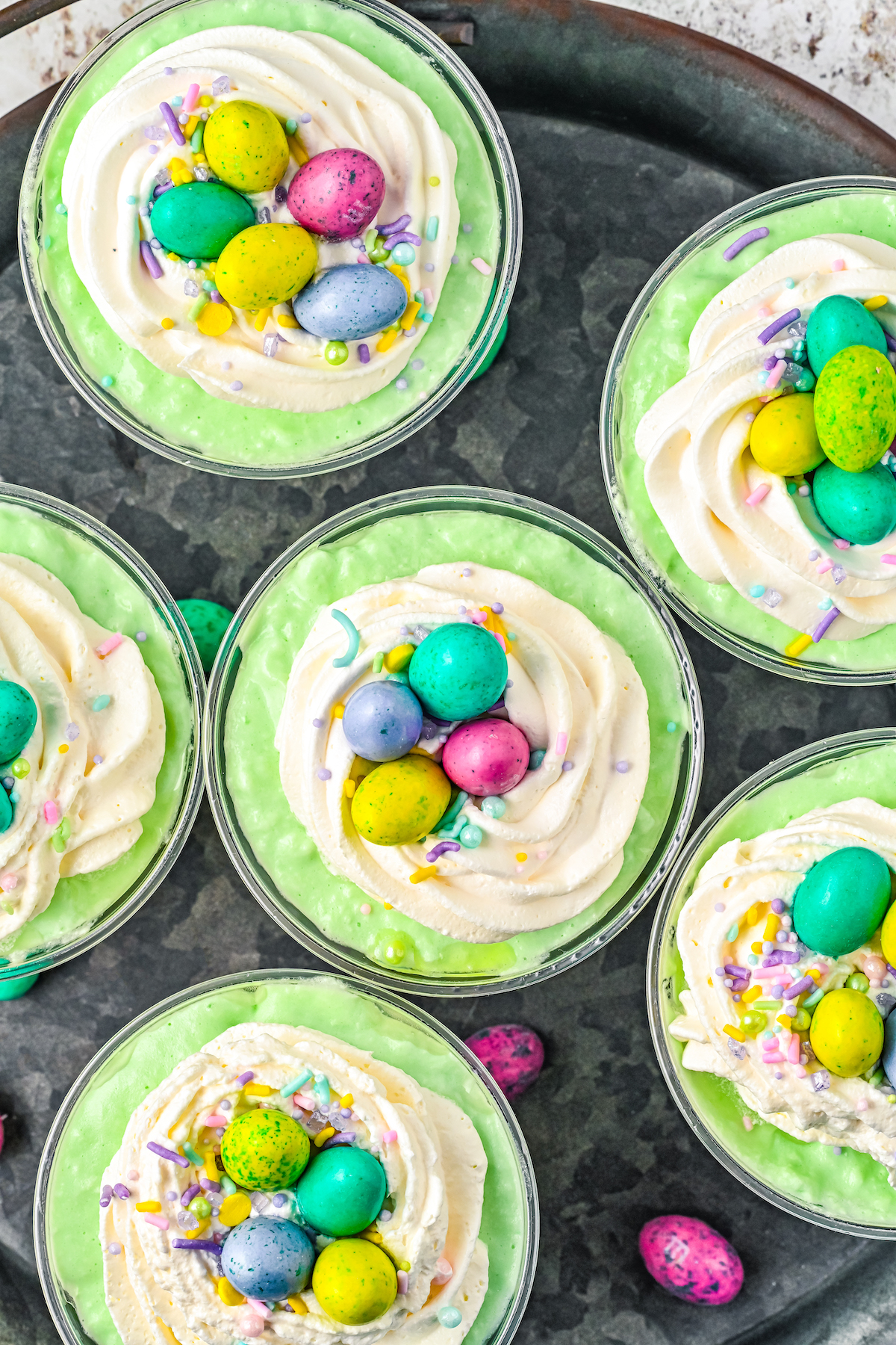 Parfaits topped with sprinkles and mini Easter eggs.
