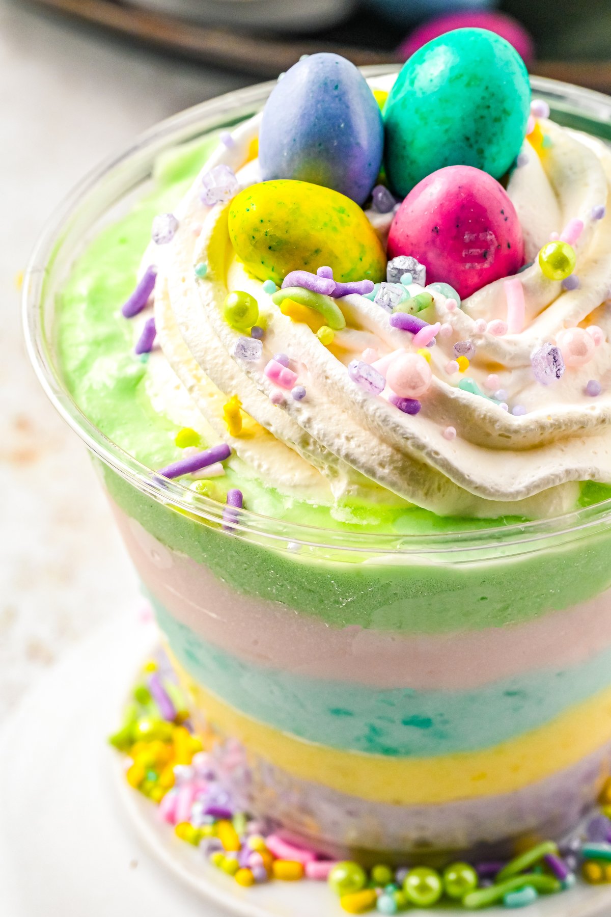 Close-up shot of whipped cream and candy topping a Jello parfait.