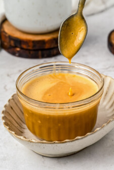 Homemade dulce de leche in a glass container.
