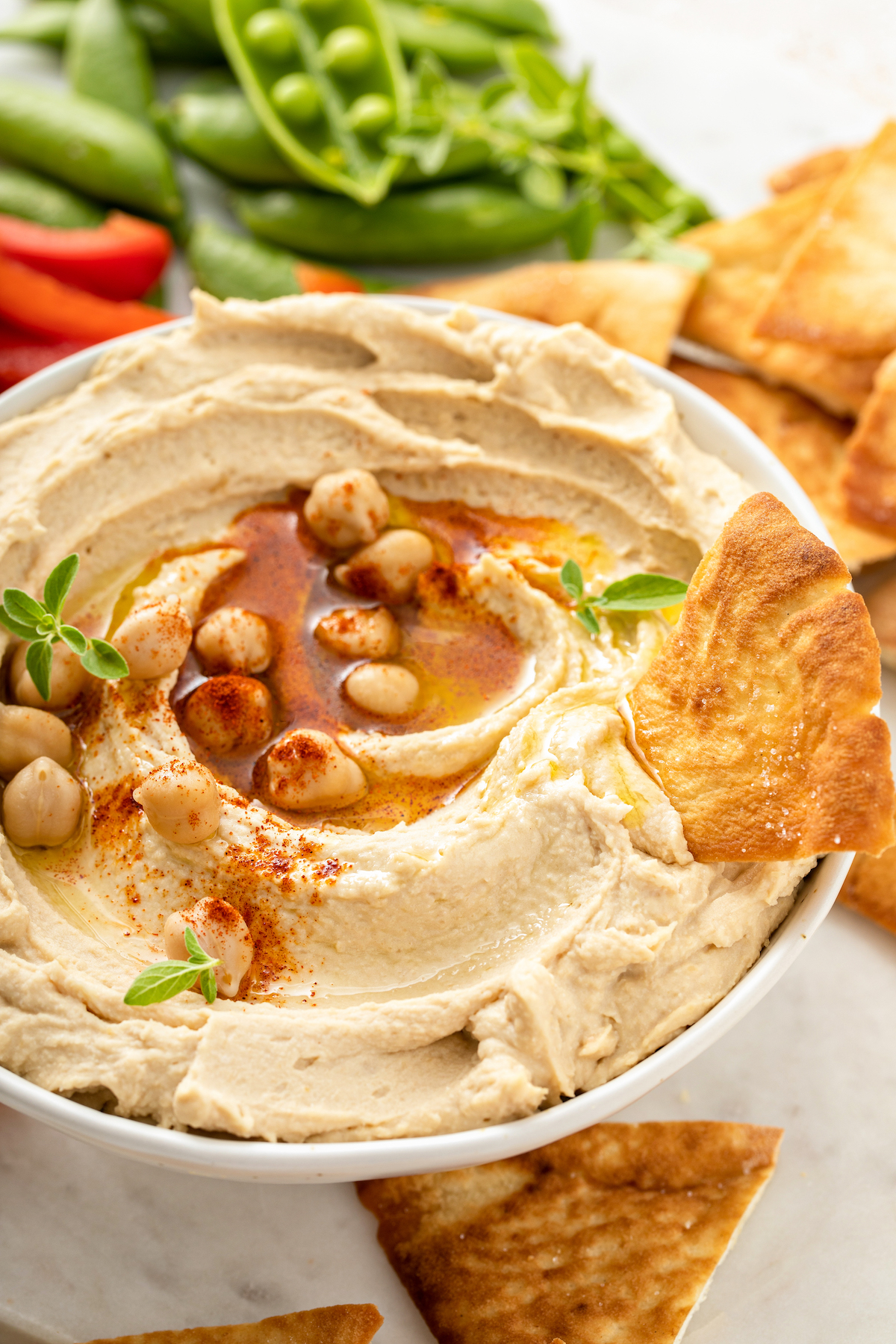 Creamy chickpea dip topped with olive oil, paprika, and extra chickpeas.