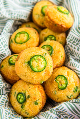 Cheddar and jalapeno cornbread muffins in a basket.