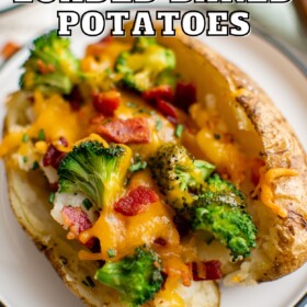 A loaded baked potato on a plate with broccoli, bacon and cheese.