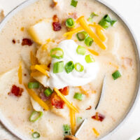 Overhead shot of blended potato soup with toppings.