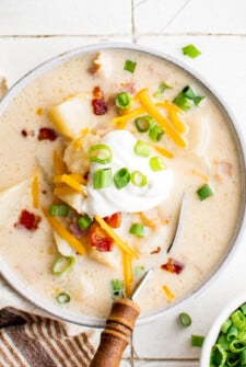 Overhead shot of blended potato soup with toppings.