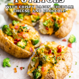 Loaded baked potatoes with broccoli, bacon and cheese on parchment paper.