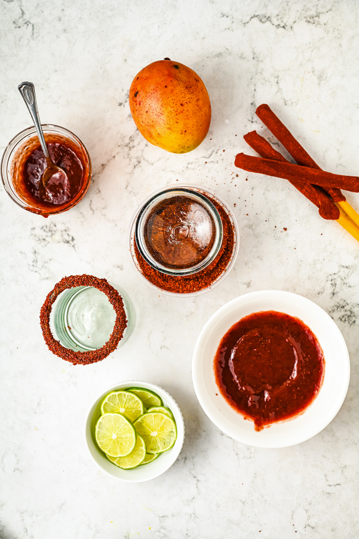 Rimming the glasses with chamoy and Tajín.