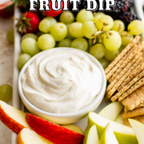 Fresh fruit and graham crackers on a plater with marshmallow dip in a bowl.