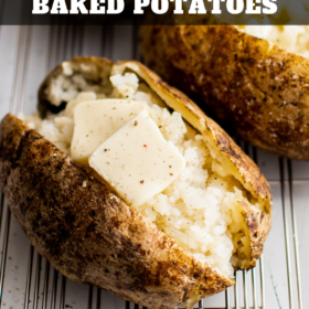 Baked potato sliced and filled with butter and salt and pepper.