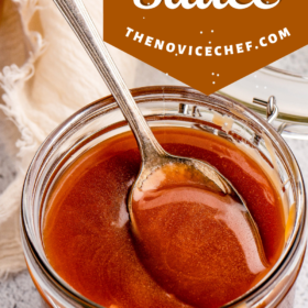A jar of salted caramel sauce with a spoon in it.