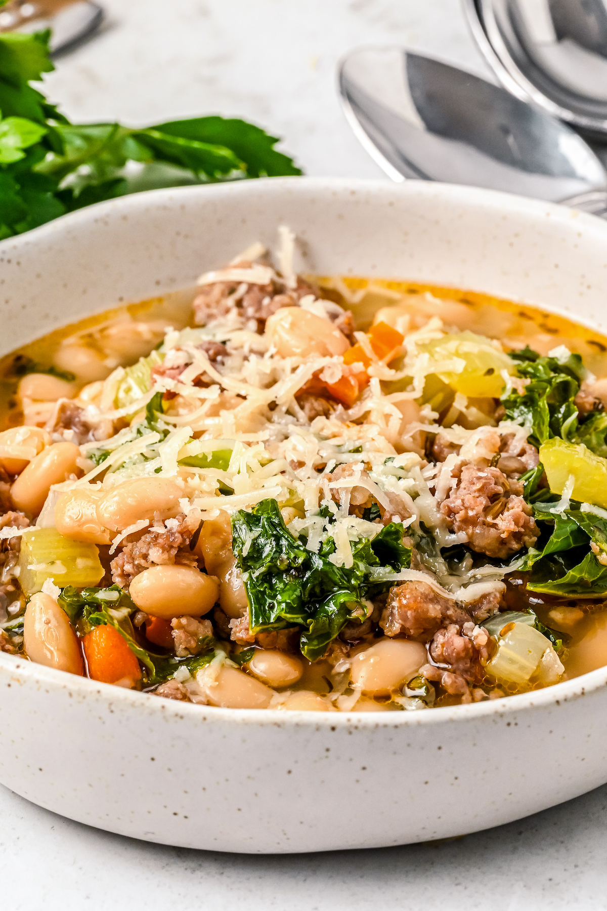 Sausage and kale soup with white beans and shredded Parmesan.