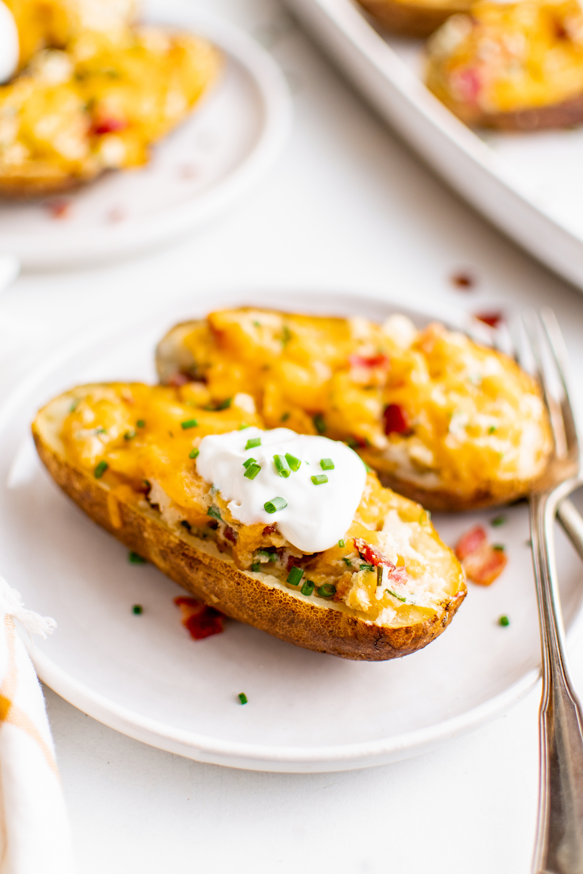 Twice baked potatoes on a white plate.