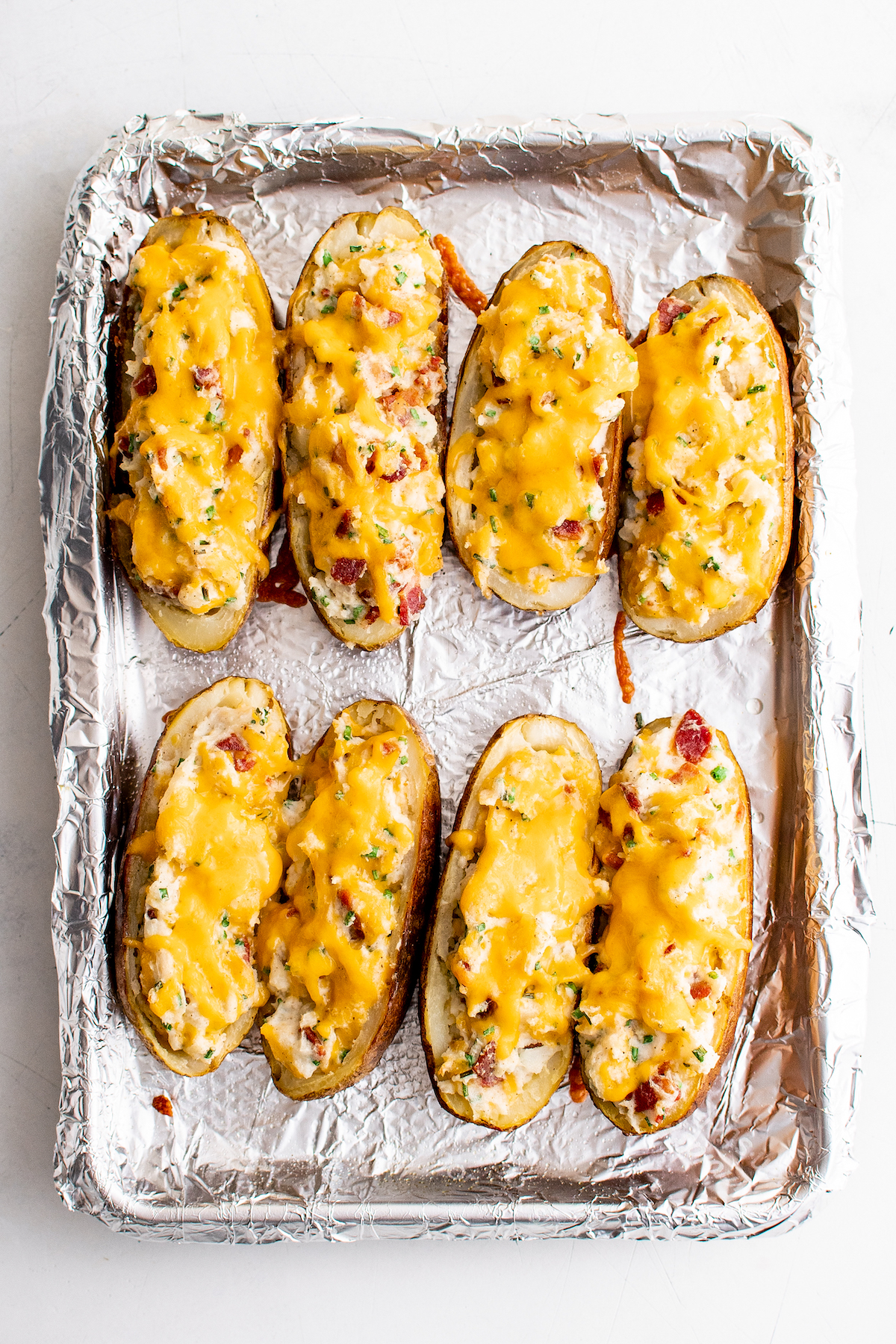 Stuffed potatoes topped with melted cheese.