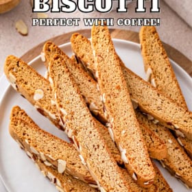 Almond biscotti cookies stacked on a white plate.