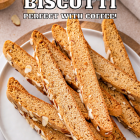 Almond biscotti cookies stacked on a white plate.