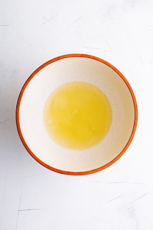Adding the egg whites to a mixing bowl.
