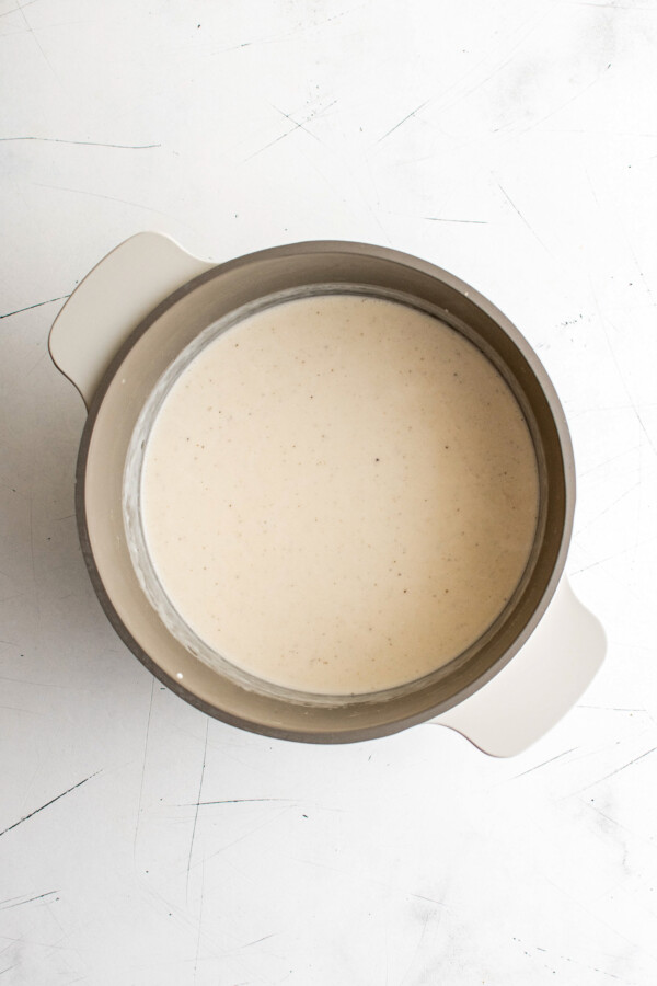 Bechamel sauce in a two-handled pot.