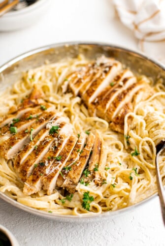 Cajun chicken alfredo with parsley on a plate.