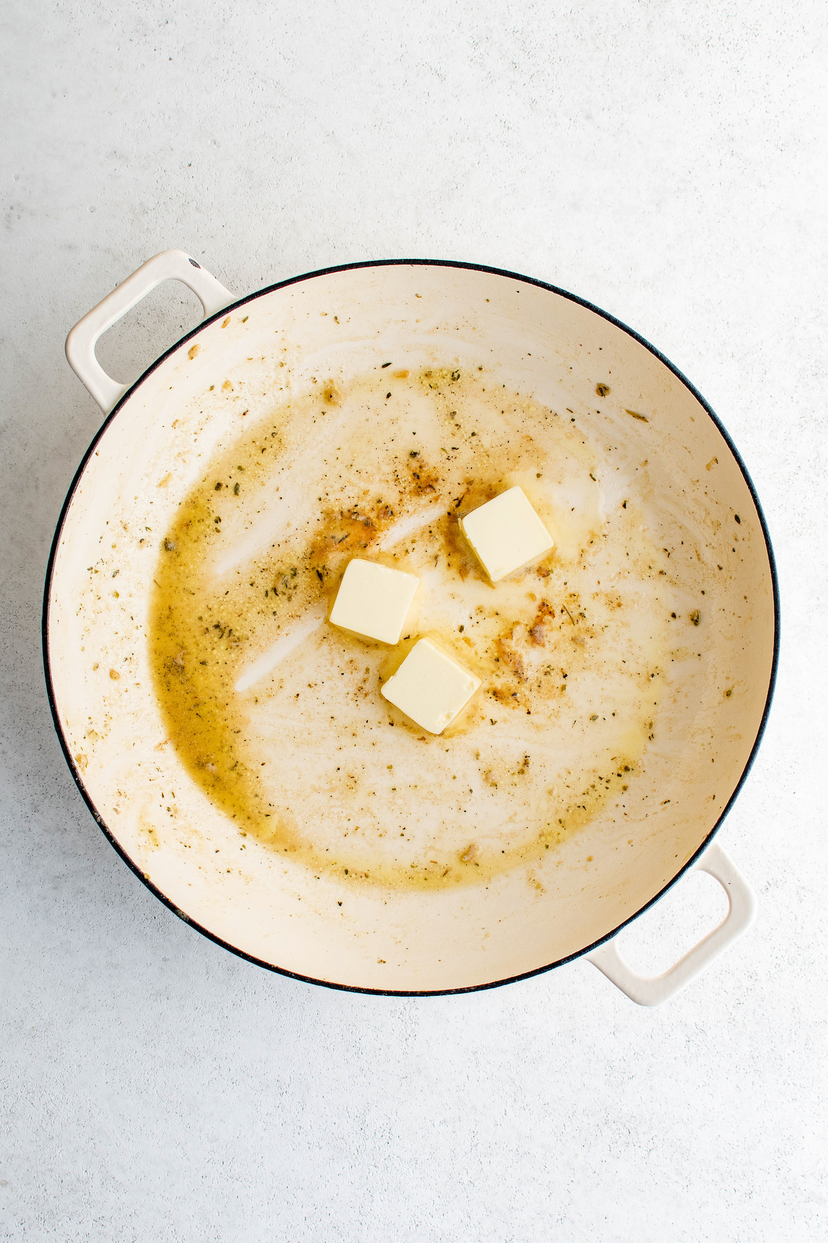 Melting the butter in the pan.