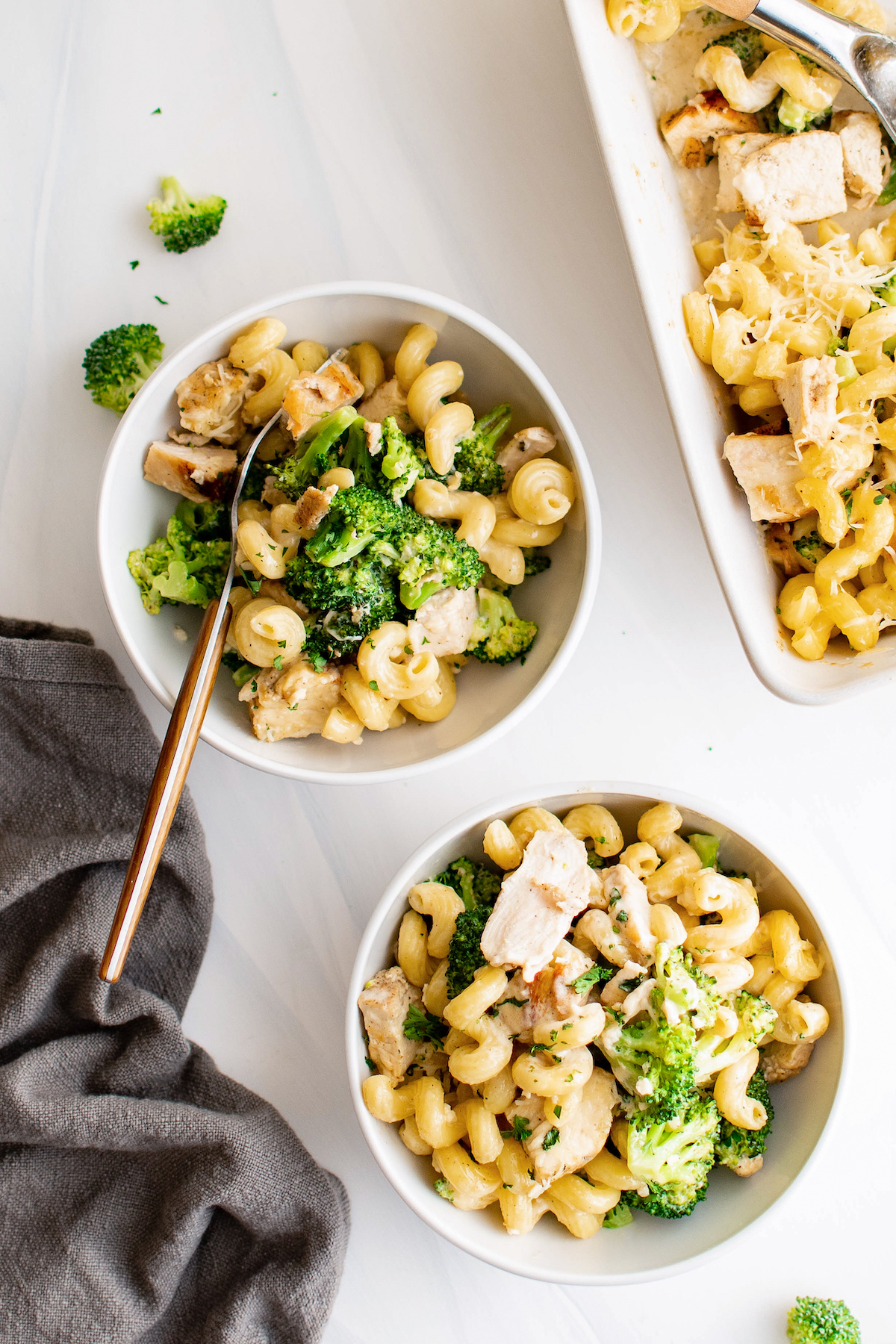 Two bowls of chicken broccoli alfredo bake. 