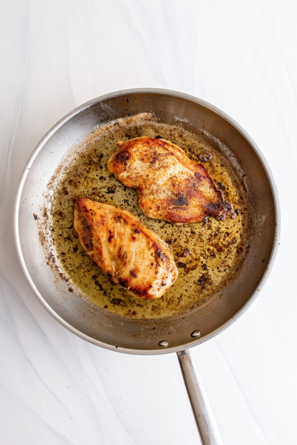 Cooked chicken breasts in a pan