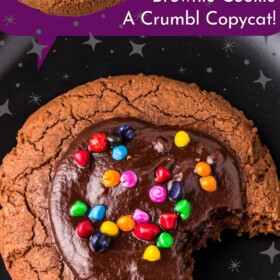 Cosmic brownie cookie on a plate with a bite taken out of it.