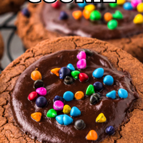 Cosmic brownie cookies stacked on a cooling rack.