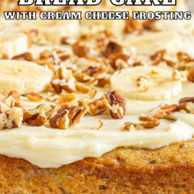 Banana bread cake with cream cheese frosting and walnuts on top.