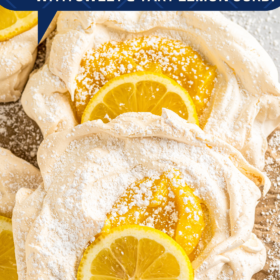 Meringues filled with lemon curd and topped with lemon wedges.