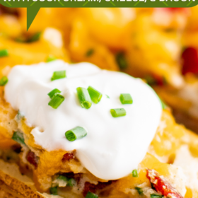 Twice baked potato with sour cream, bacon and chives on top.