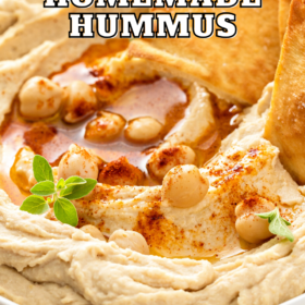 Hummus in a bowl with pita chips.