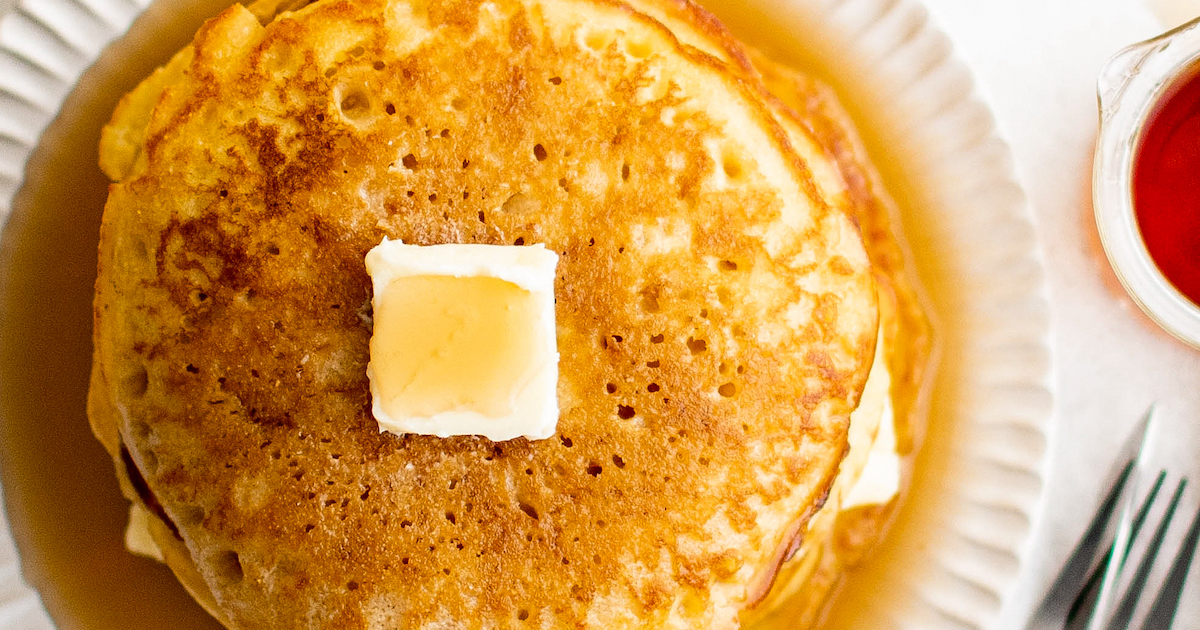 Cornmeal pancakes with butter and syrup.