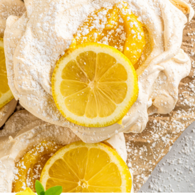 Meringues filled with lemon curd and dusted with powdered sugar.