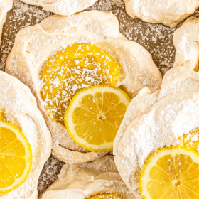 Lemon meringues with lemon curd and dusted with powdered sugar.