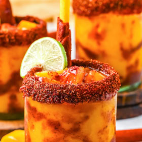 Mangonada on a coaster with a tamarind candy straw.