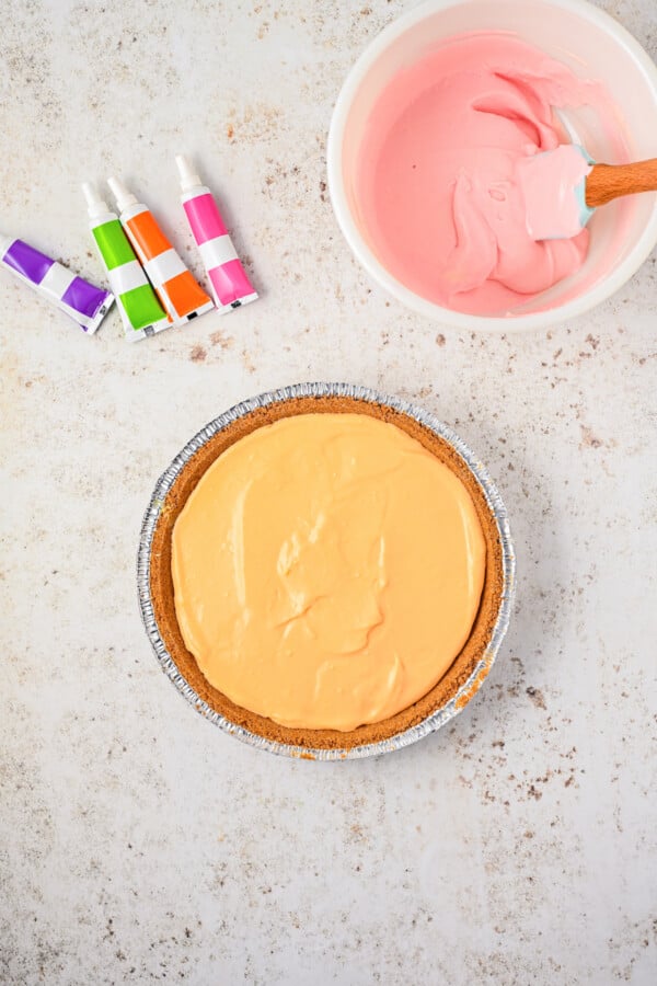 Adding more colored filling to a cream cheese.