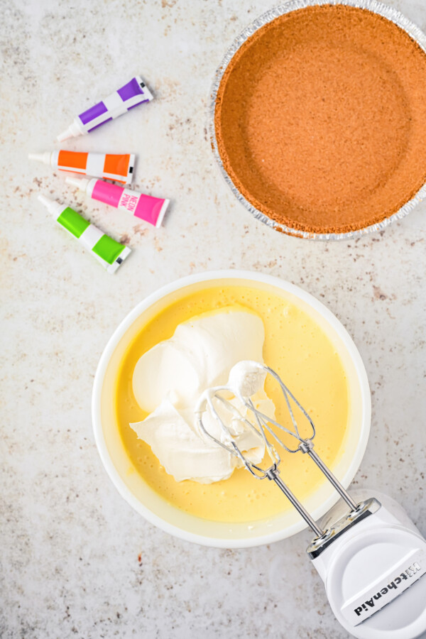 Beating whipped topping into a mixing bowl.