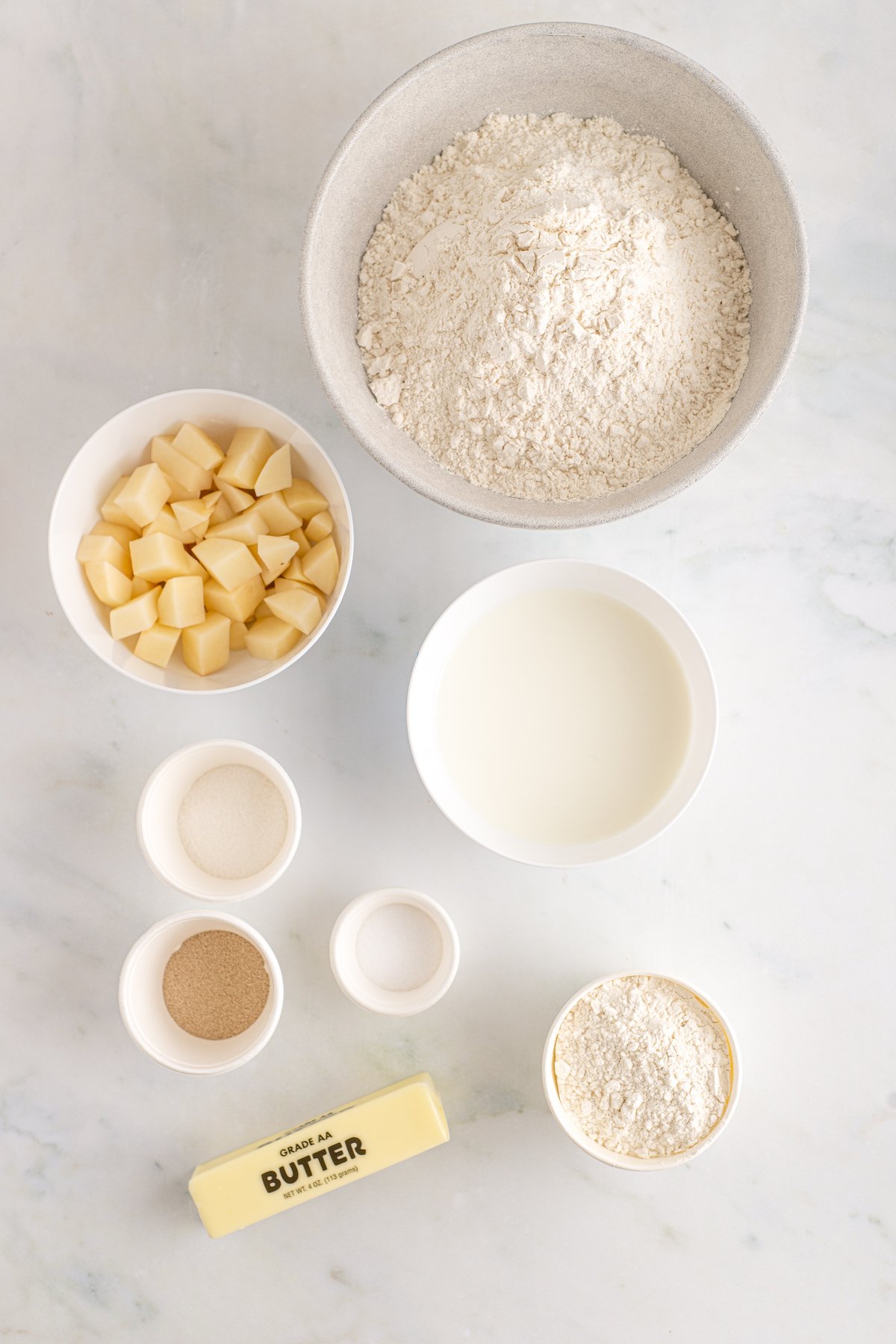Bread ingredients measured and arranged on a work surface.