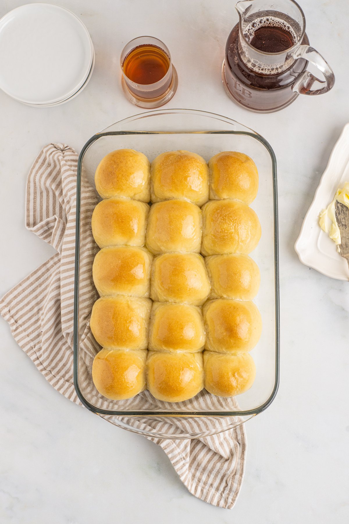Baked homemade potato rolls in a glass dish.