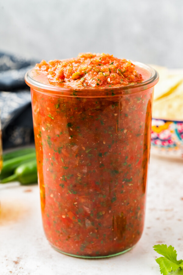 Salsa in a glass jar. 