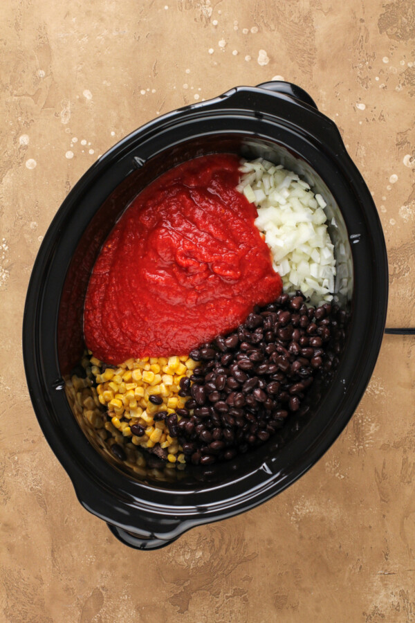 Taco pasta ingredients in a slow cooker.