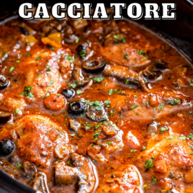 Chicken cacciatore in a slow cooker with herbs on top.